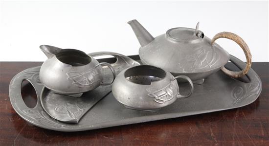 A Liberty English pewter four piece teaset and a similar crumb scoop
